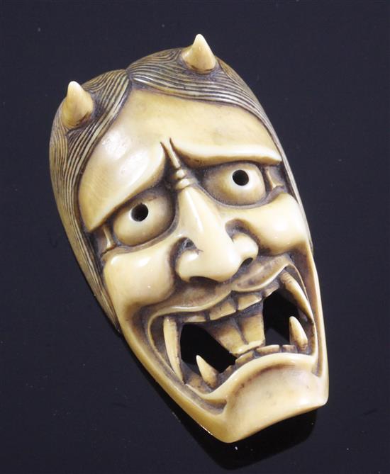 A Japanese Oni mask Manju netsuke, 19th century, 4.9cm